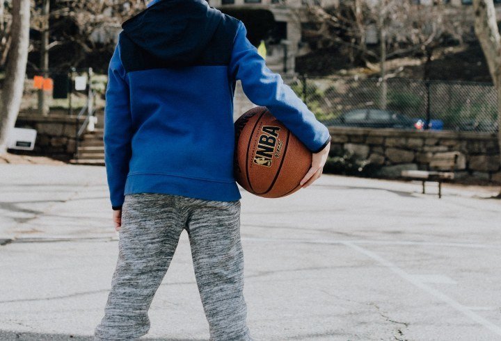 basketball tryouts boy holding basketball on outdoor court